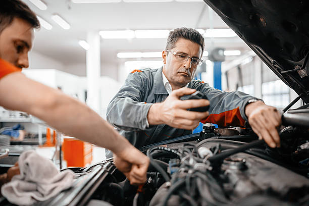 Car mechanics working and maintaining car
