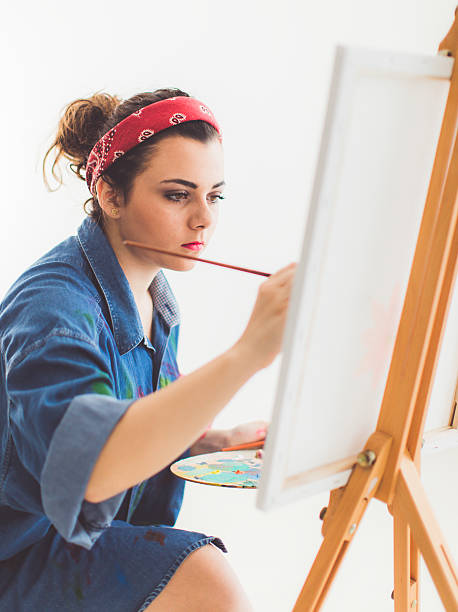istock Young girl paints on canvas 627741010