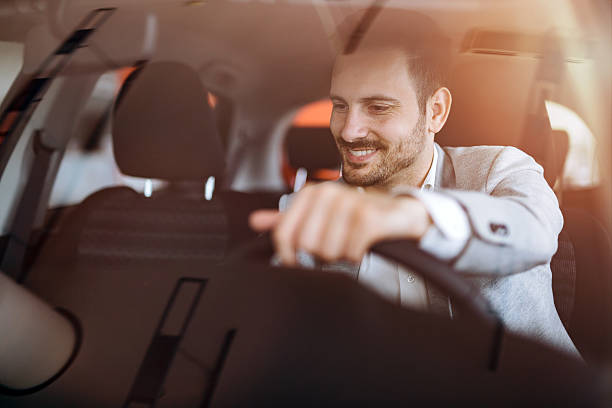 handsome geschäftsmann autofahren - driving new car driver stock-fotos und bilder