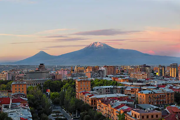 Yerevan in Armenia and the two peaks of the Mount Ararat at the sunrise.