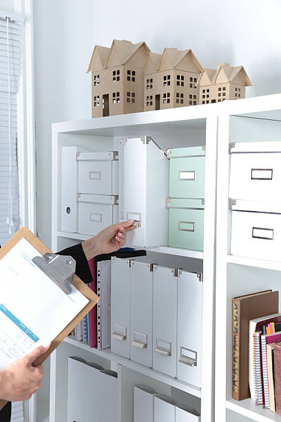 istock File folders, standing on shelves in the background 627744760