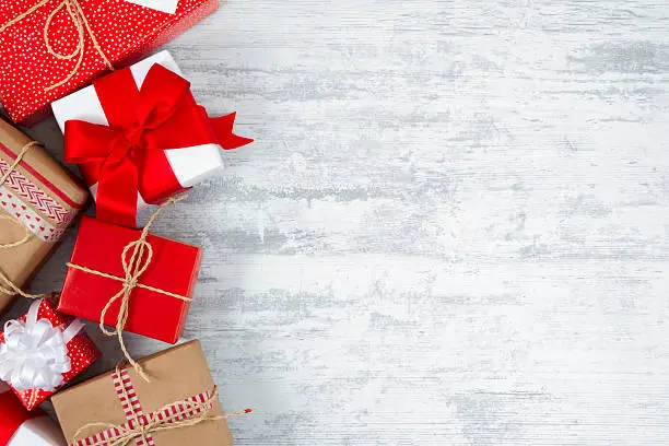 Photo of Christmas Gift Boxes on Frozen Wooden Table