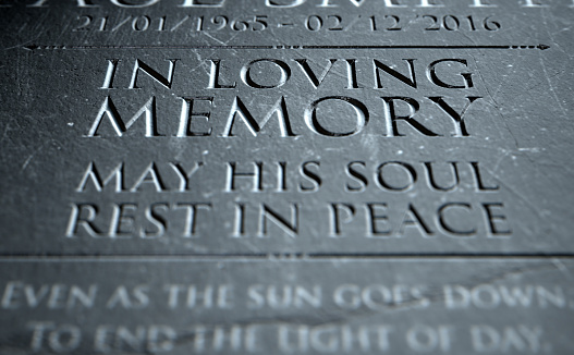 A 3D render of closeup of a carved and etched tombstone highlighting the word in loving memory