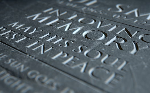 A 3D render of closeup of a carved and etched tombstone highlighting the word in loving memory