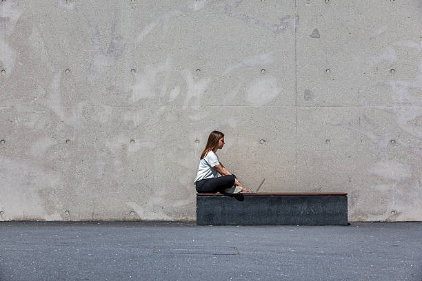 istock girl, laptop, concrete 627748166