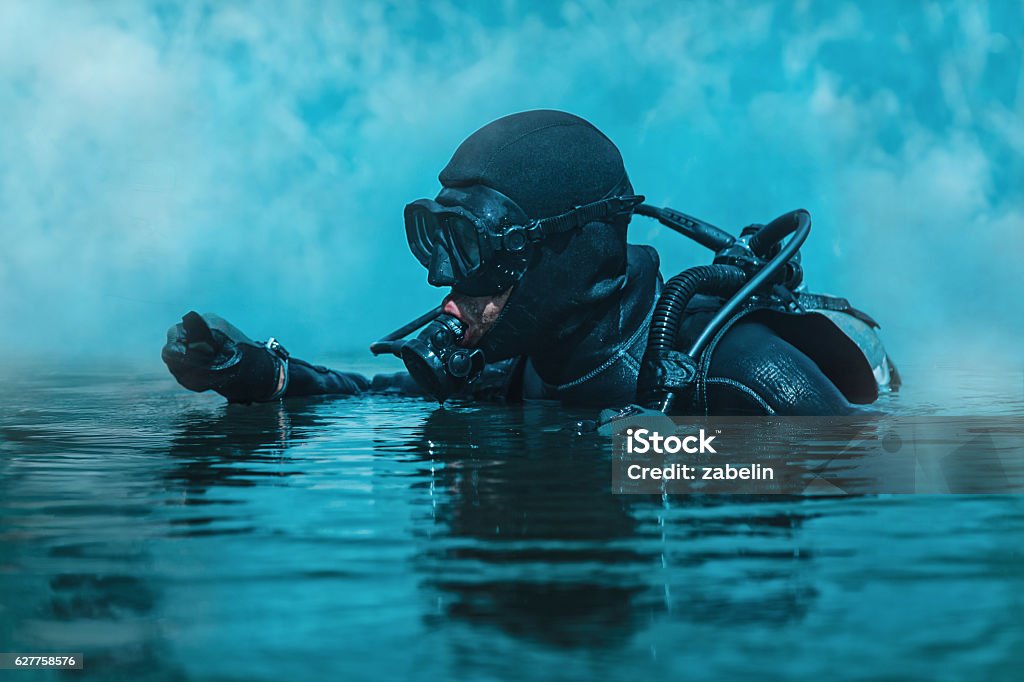 Navy SEAL frogman Navy SEAL frogman with complete diving gear and weapons in the water Underwater Diving Stock Photo