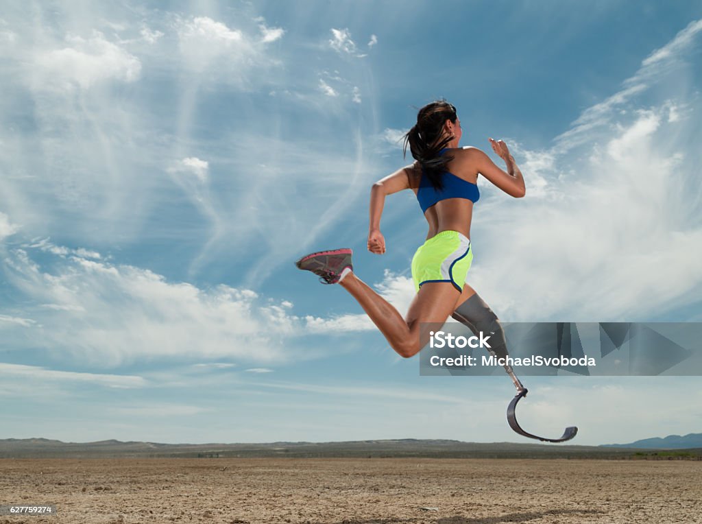 Asian Women With Prosthetic Leg Running In The Desert Prosthetic Equipment Stock Photo