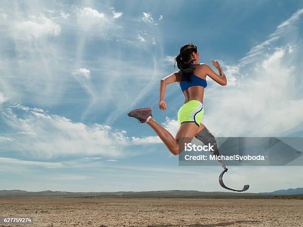 Asian Women With Prosthetic Leg Running In The Desert Stock Photo - Download Image Now