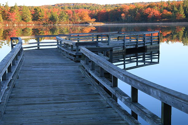 istock Fall colors view fron a fishing dock 627759952