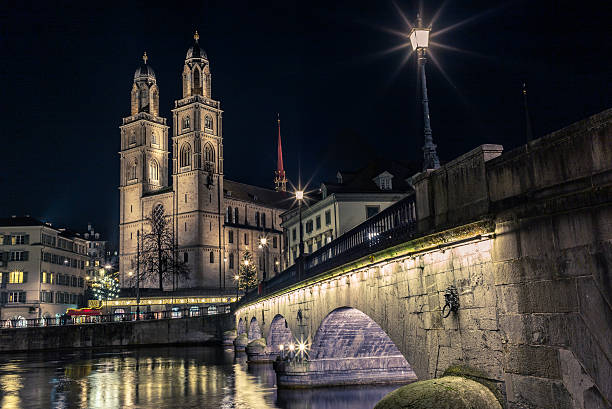 istock Grossmunster in Zurich from the Limmat at night - 3 627760462