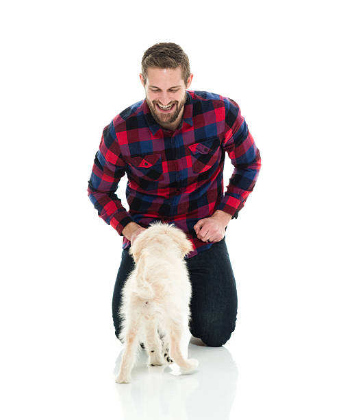 istock Smiling casual man playing with his dog 627760660