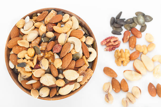 istock Mixed nuts top view in wooden bowl 627761130