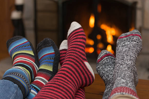 Foot and Suck Behind Fireplace Foot and Suck Behind Fireplace apres ski stock pictures, royalty-free photos & images