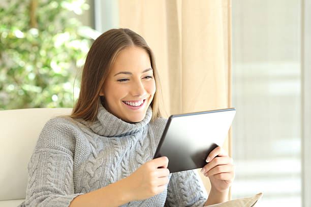 Girl using a tablet at home in winter