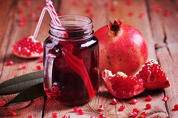 Natural pomegranate juice in a Mason jar stock photo