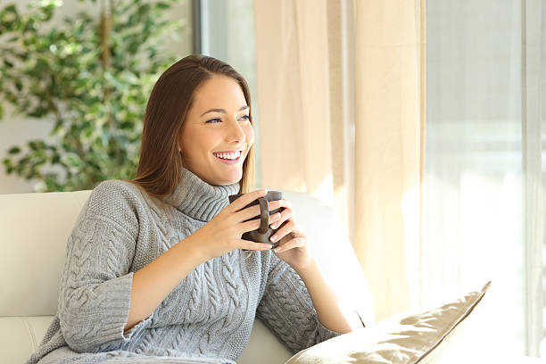istock Pensive woman at home in winter 627762300