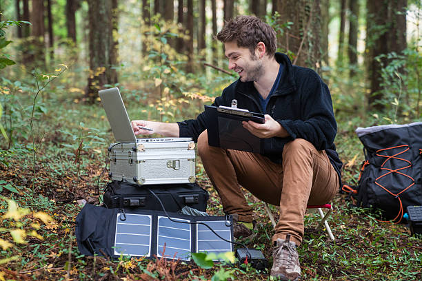 istock Man working at a solar powered portable research field station 627771674