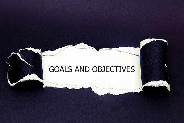 istock Goals and Objectives words written under torn paper. 627776544