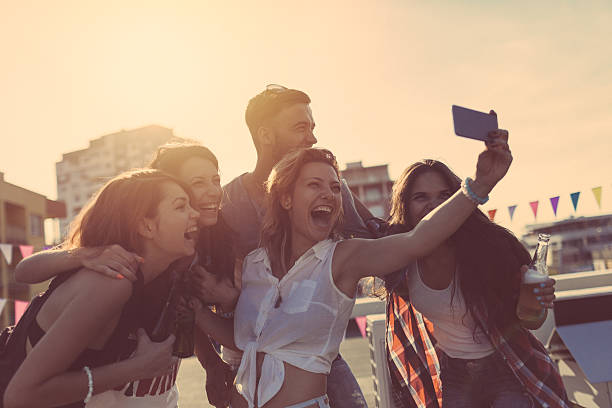 istock Friends taking selfie on rooftop terrace 627777026