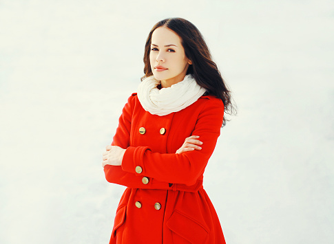 Fashion beautiful young woman wearing a red jacket in winter day