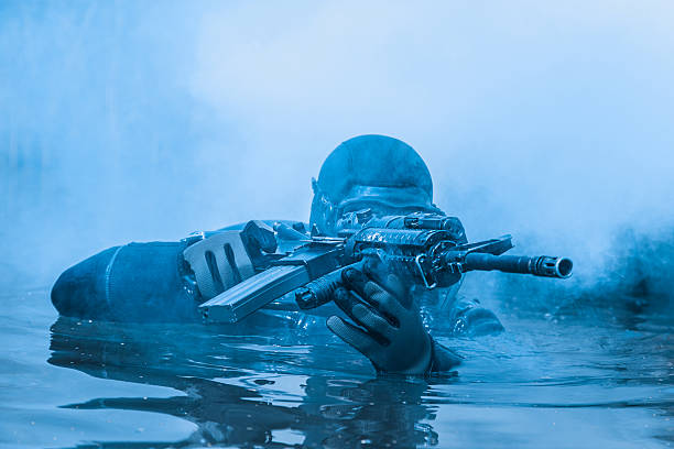 Navy SEAL frogman Navy SEAL frogman with complete diving gear and weapons in the water immersed in their work stock pictures, royalty-free photos & images