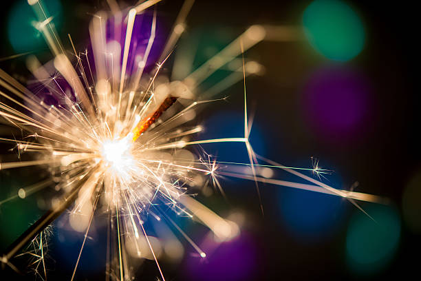 istock Christmas sparklers and background with colorful bokeh 627796614