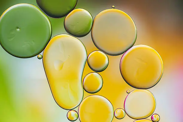 Photo of drops of oil and air bubbles on the water