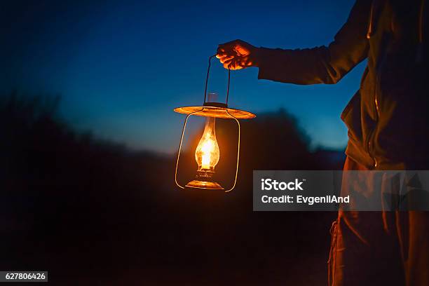 Man Holding The Old Lamp With A Candle Outdoors Stock Photo - Download Image Now - Lantern, Holding, People