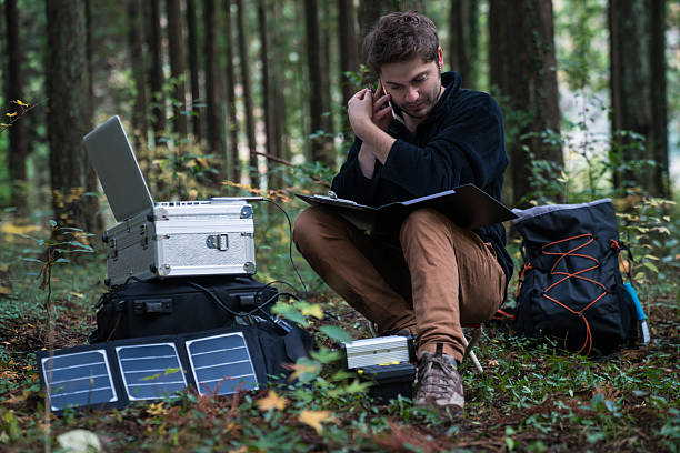 istock Scientist on a smartphone working remotely in the forest 627812048