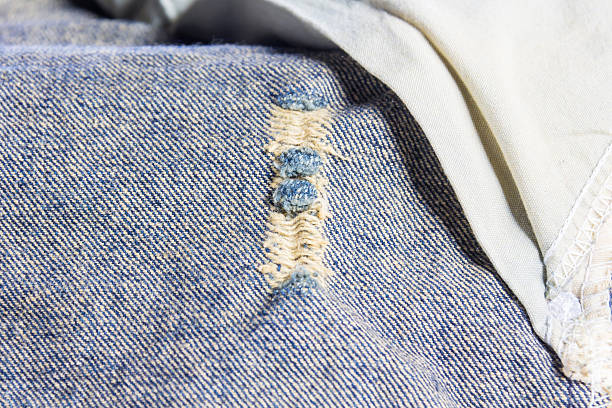 istock jeans stacked on a wooden background 627813896