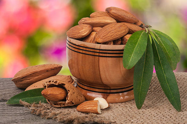 istock almonds in a bowl on the old wooden board with 627816614