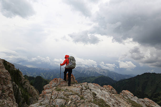istock successful woman backpacker enjoy the view on mountain peak 627816662
