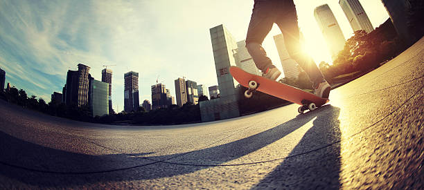 skateboarder skateboarding at sunrise city skateboarder skateboarding at sunrise city Ollie stock pictures, royalty-free photos & images