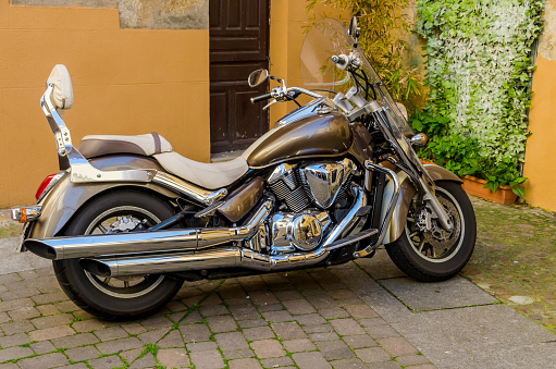 Polished motorbike parked near house entrance