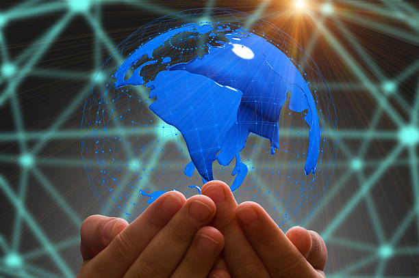 istock kid's hand holding globe in dark background 627838620