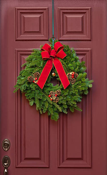 istock Christmas wreath on a red door 627839800