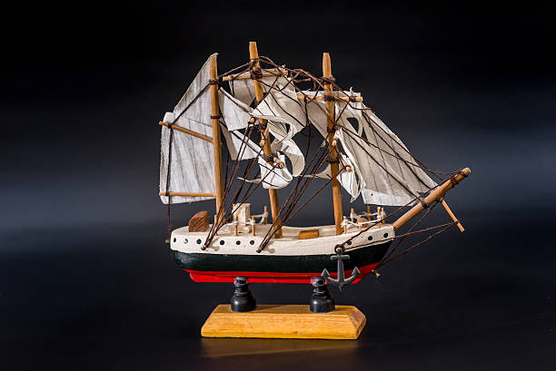 istock Wooden ship toy model, isolated on black background 627840132