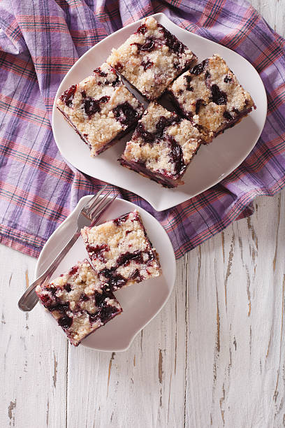 istock Sponge cake with blueberries close-up on a plate. Vertical 627840600