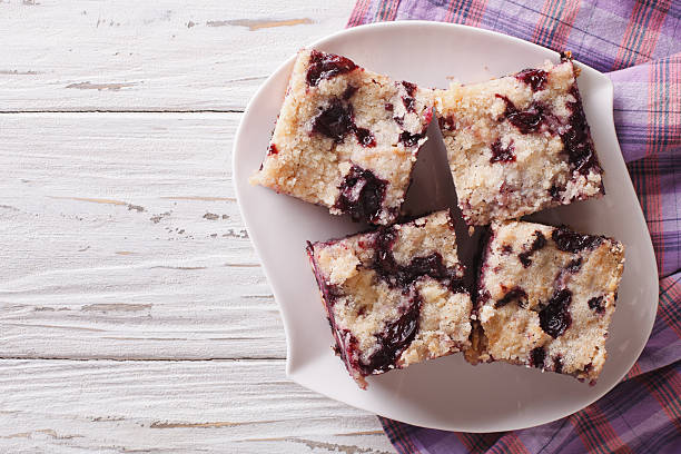 Berry pie with blueberries close-up. horizontal top view Berry pie with blueberries close-up on a plate on the table. horizontal view from above buckle stock pictures, royalty-free photos & images