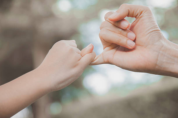 istock mother and her child hooking their fingers 627841300