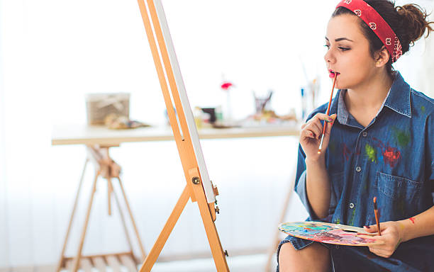 istock Young girl paints on canvas 627852308