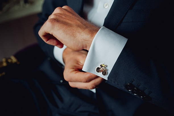 istock Groom buttoning a shirt on  white wedding 627853206