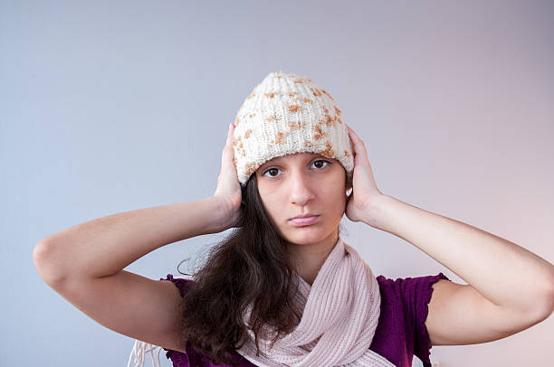 istock The girl in hat closes his ears 627853920