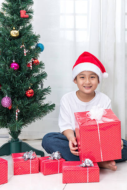 istock Asian Chinese little boy holding Christmas gift box 627855900