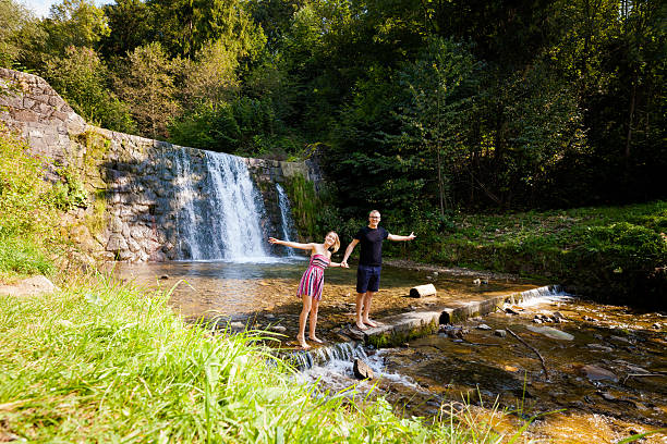 istock Beautiful young couple by waterfall 627856244