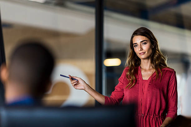 istock Businesswoman sharing ideas in board meeting 627856518