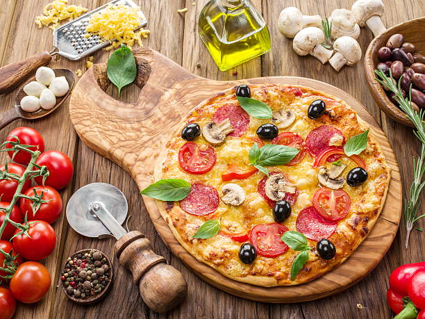 istock Pizza with mushrooms, salami and tomatoes. 627870808