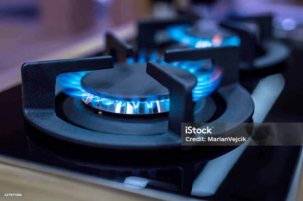 Stove. Cook stove. Modern kitchen stove with blue flames burning Stove. Cook stove. Modern kitchen stove with blue flames burning. Natural Gas Stock Photo