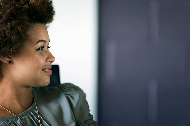 istock Smiling businesswoman looking away at office 627871670