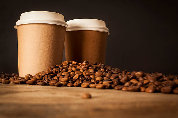 istock Paper cups of coffee on black background 627873498